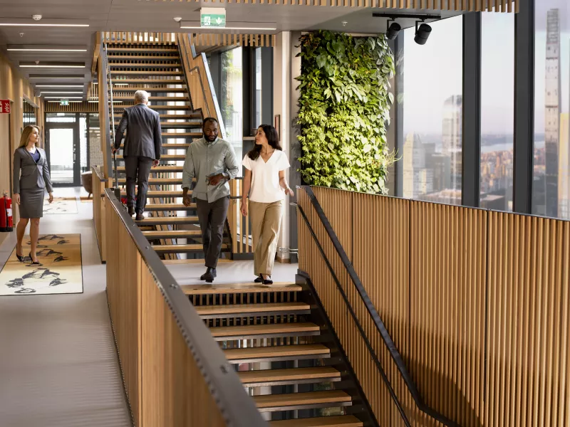 People walking down stairs in office