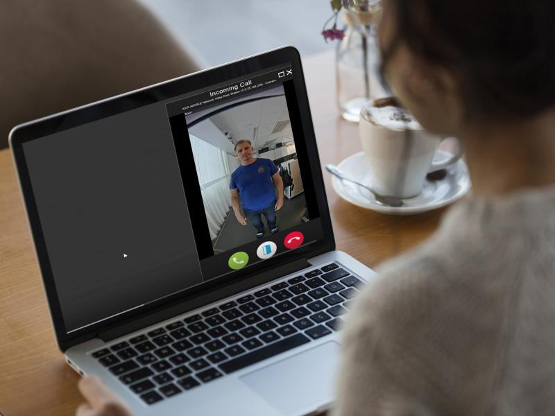 person sitting infron of a laptop screen