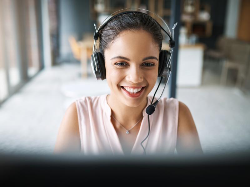 young woman, working at a call center, smiling