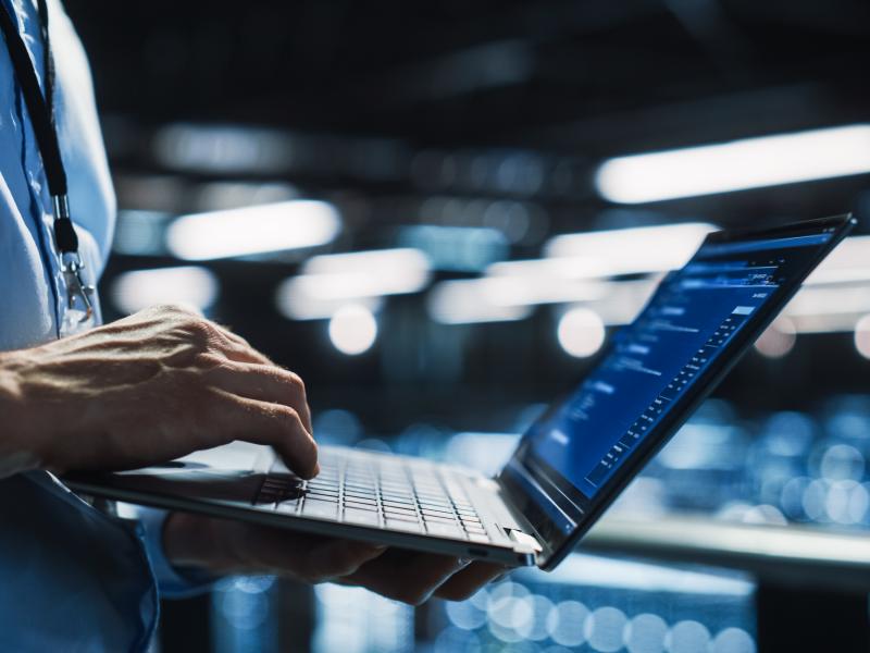 Person doing server system maintenance on laptop.