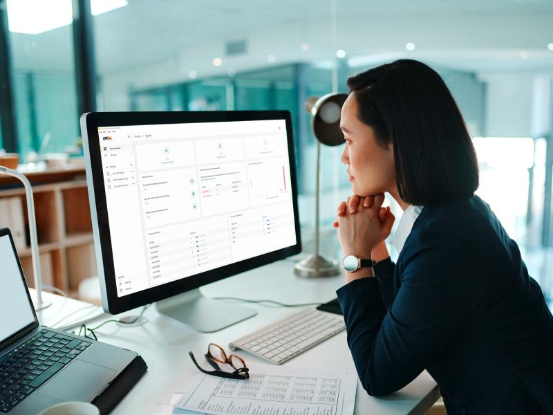 Business woman looking at computer screen at an office.