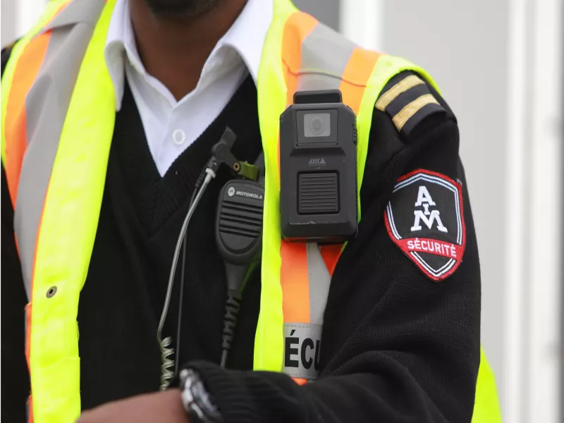 Close up of body worn camera on safety vest of AIM security guard