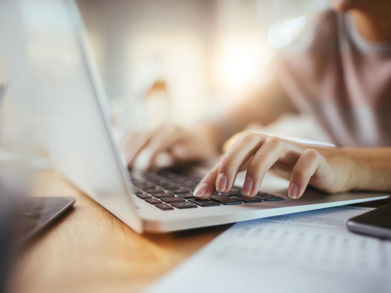 hands typing laptop