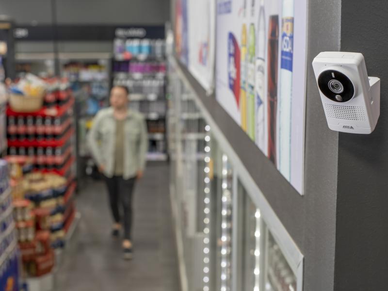 AXIS M1075-L Box Camera, mounted on a pole in a gas station store