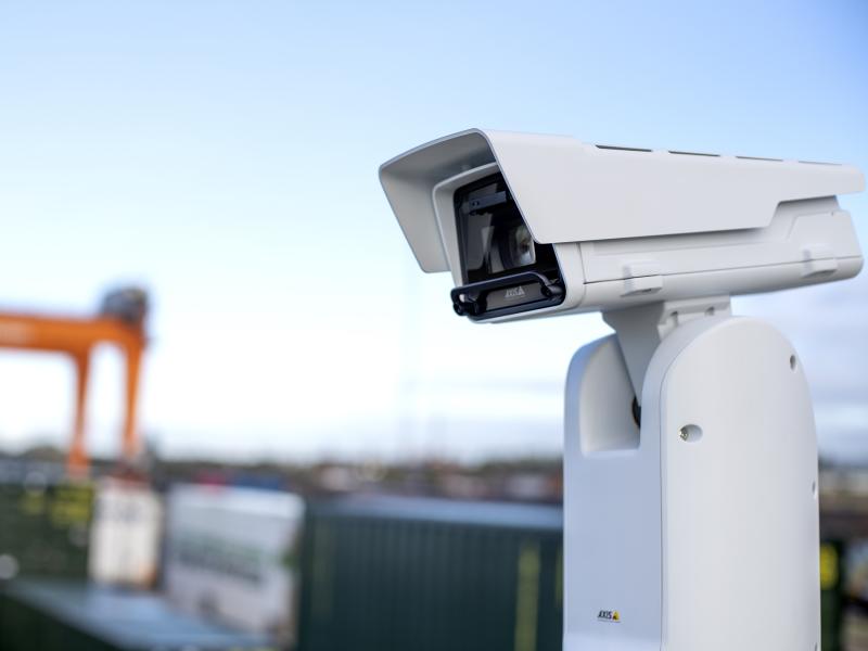 AXIS Q8615-E PTZ Camera, mounted at a distribution terminal. Light blue sky in the background. 