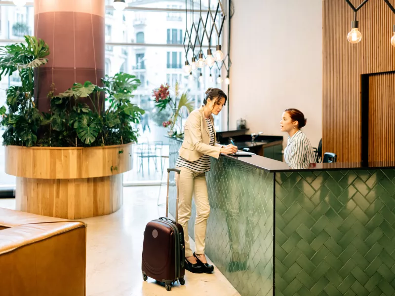 woman checking in, in the hotel reception