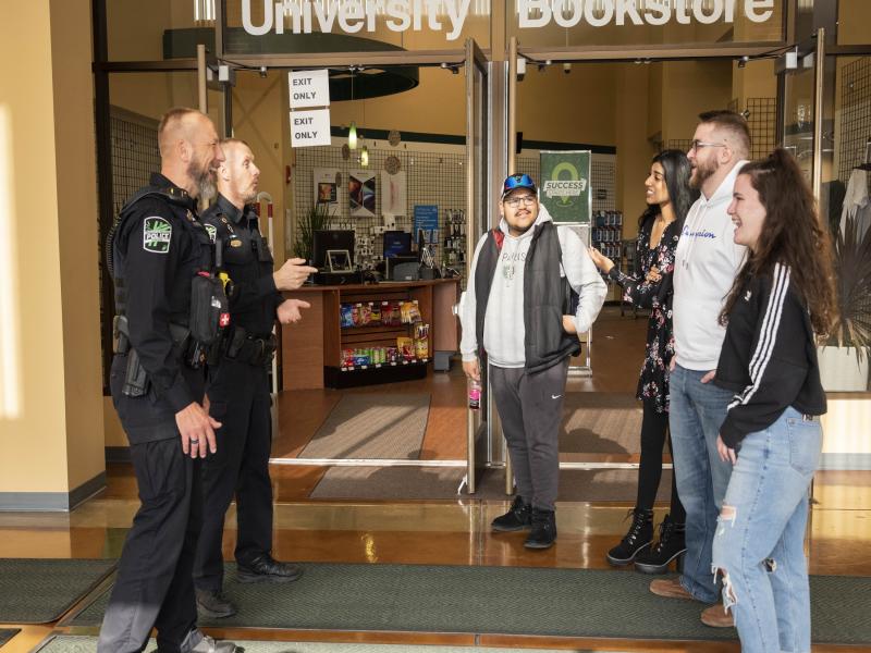 2 campus officers speak with students