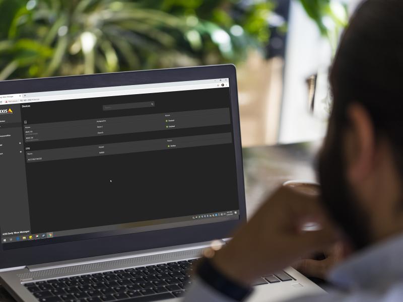 Person sitting by a laptop