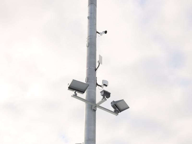 Light pole at football stadium with cameras, radar, and horn speaker