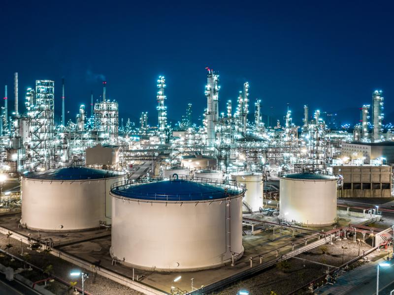 Oil refinery tanks at night.