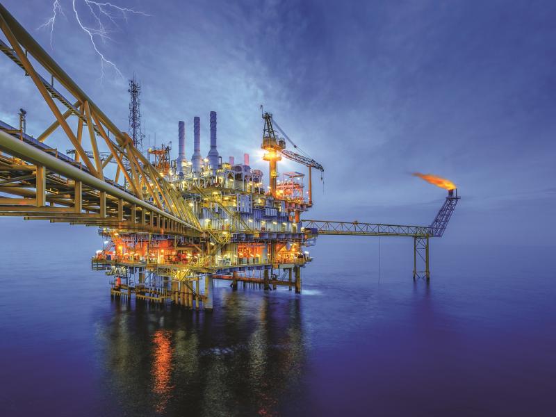 oil rig in the ocean, at night