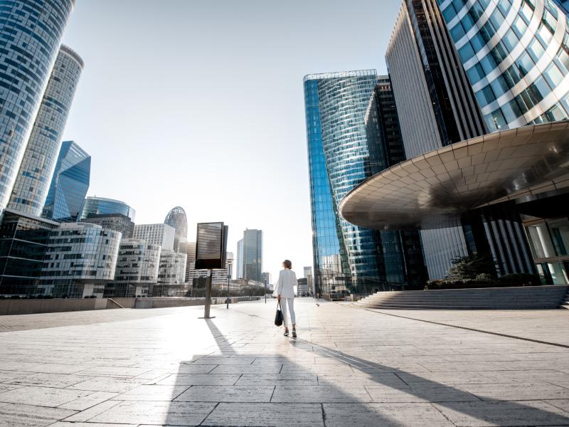 woman walking in a city square