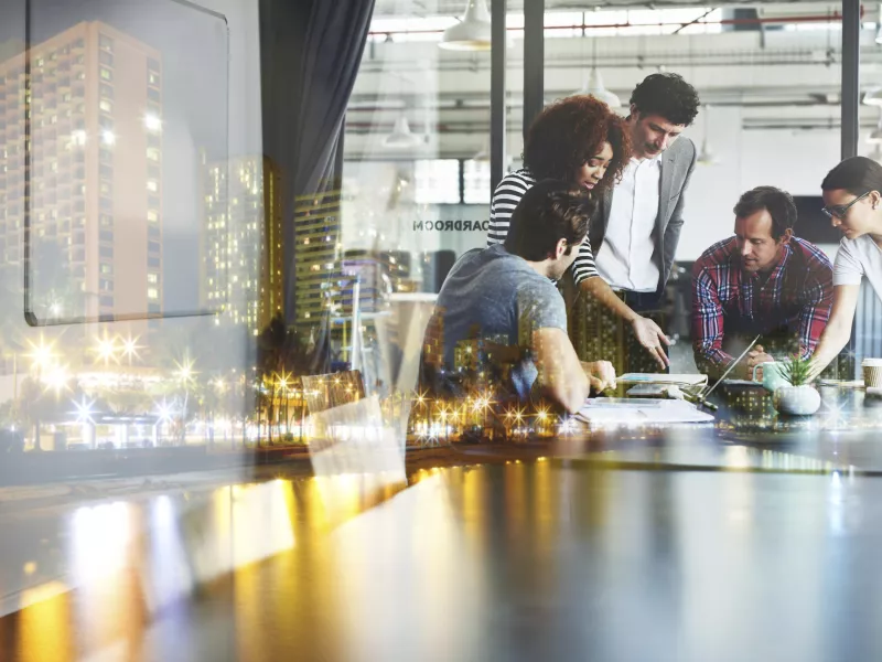 People talking during business meeting, gathered around a table.