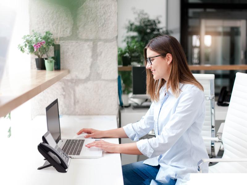 women sitting in front of a laptop screen