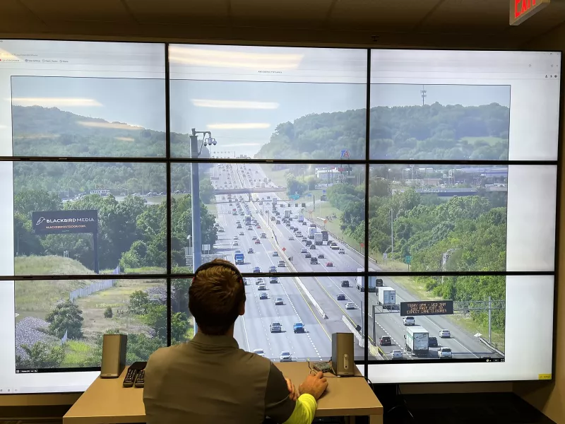Scientist observing video streams on monitors