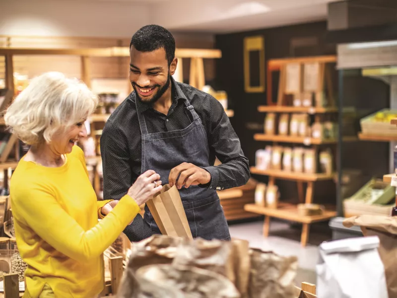 Man helping woman customer bulk foods store
