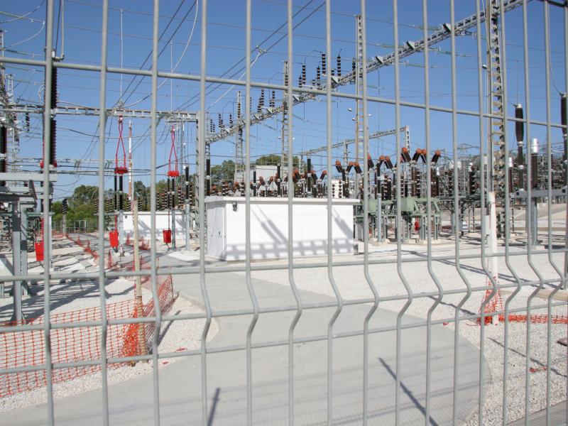 Electrical substation through a fence