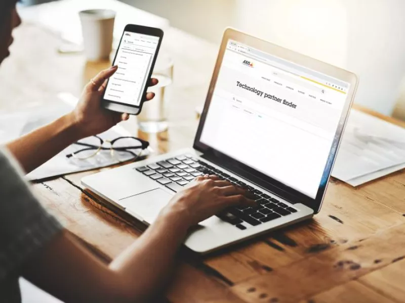 businesswomen cellphone laptop office axis partner finder