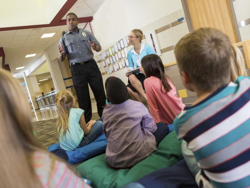 Officer young students talking school