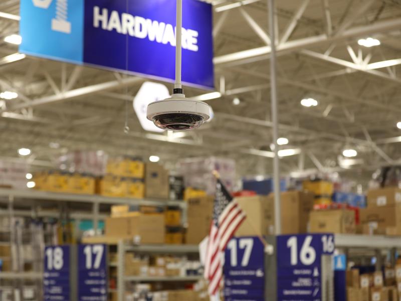 Camera in Lowe's with Hardware sign in background
