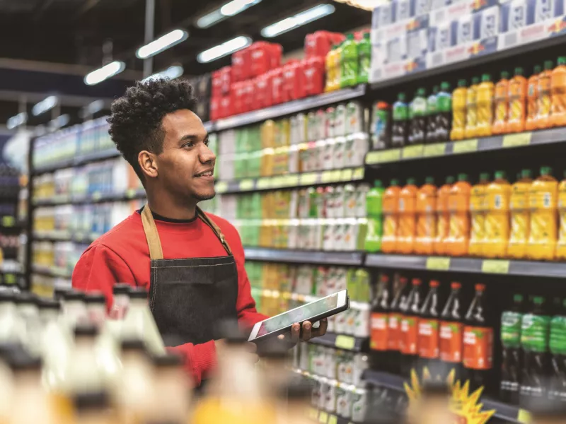man working groceries tablet