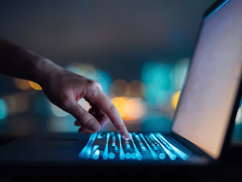 hand typing on a laptop