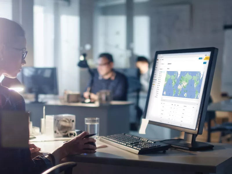 women looking at a screen showing multisite management software