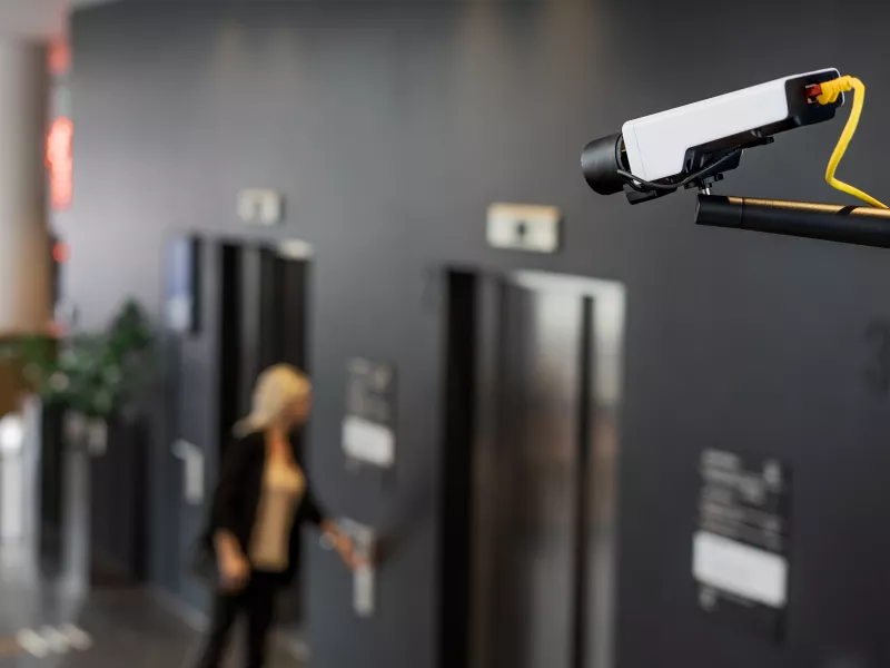 Camera looking at woman near elevators indoor