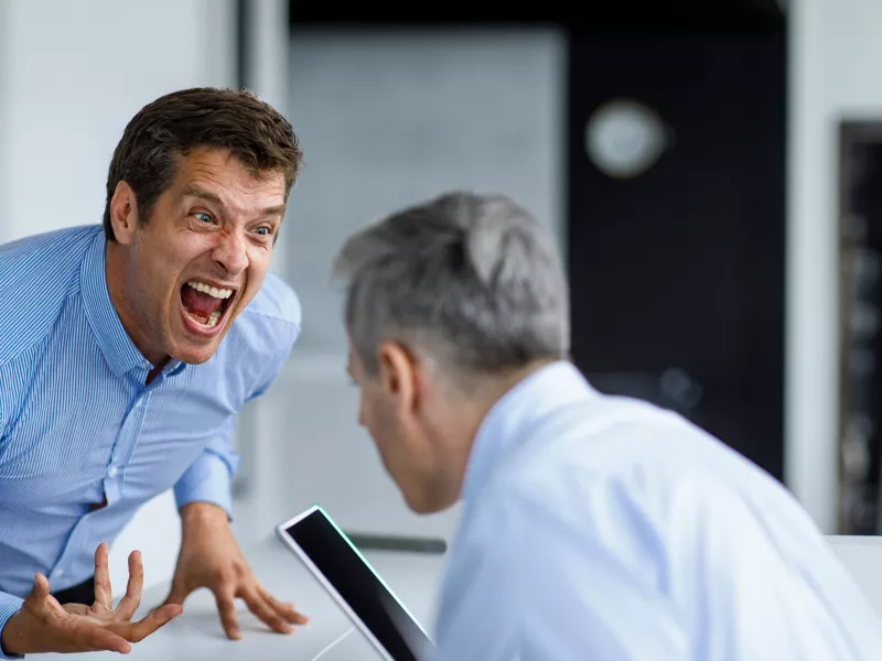 Businessman screaming aggressively in office