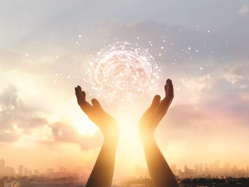 Hands holding futuristic tech brain