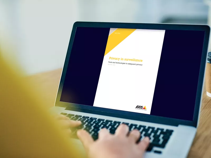 laptop with whitepaper on screen and hands