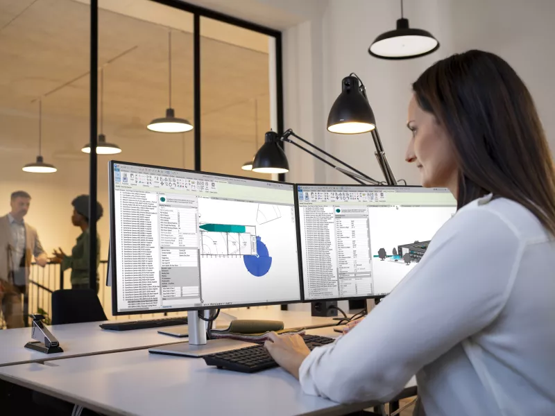 A&E woman working on two computer screens