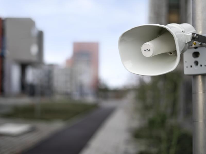 AXIS C1310-E Network Horn Speaker, mounted on a wall in an outdoor environment