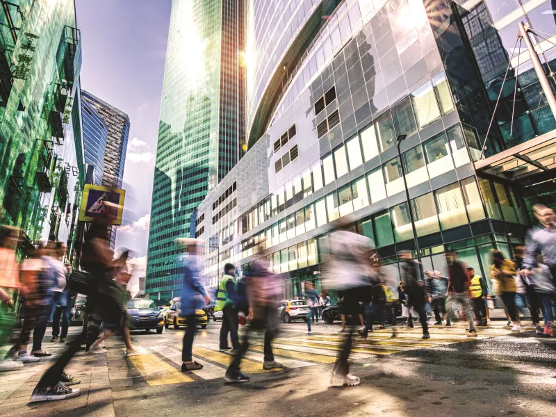 crosswalk in a big city, peole in motion