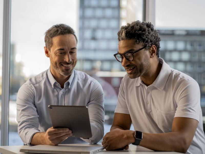 CPP two men discussing over tablet