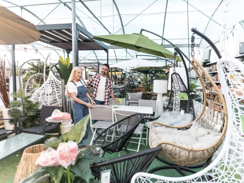 Happy couple looking for outdoor furniture