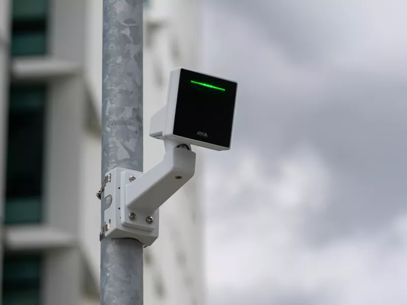 AXIS D2210-VE Radar mounted on pole, green led lights, dramatic clouds in background