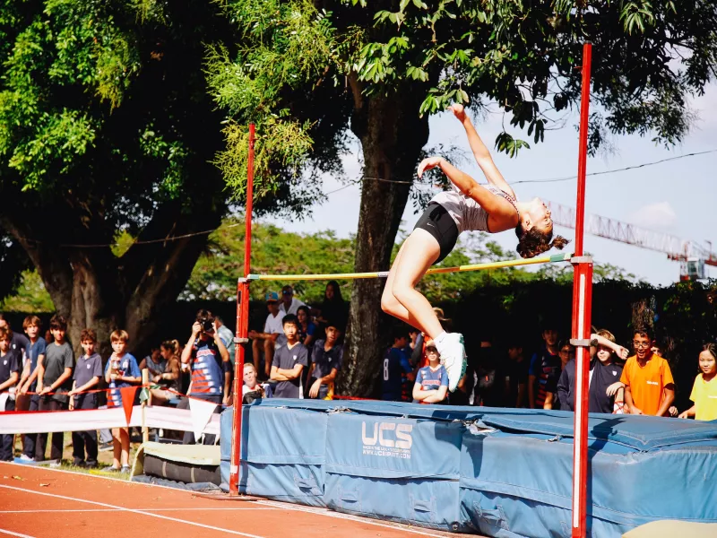 Student clearing high jump at El Salvador school
