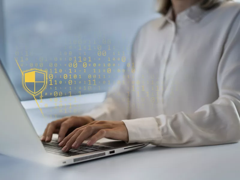 woman on laptop cybersecurity overlay