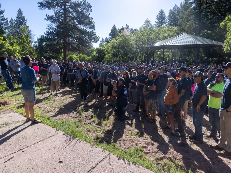 Leader speaking to large group of workers