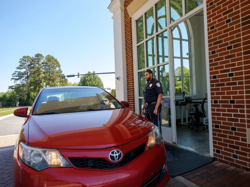 Police officer speaking with driver in car