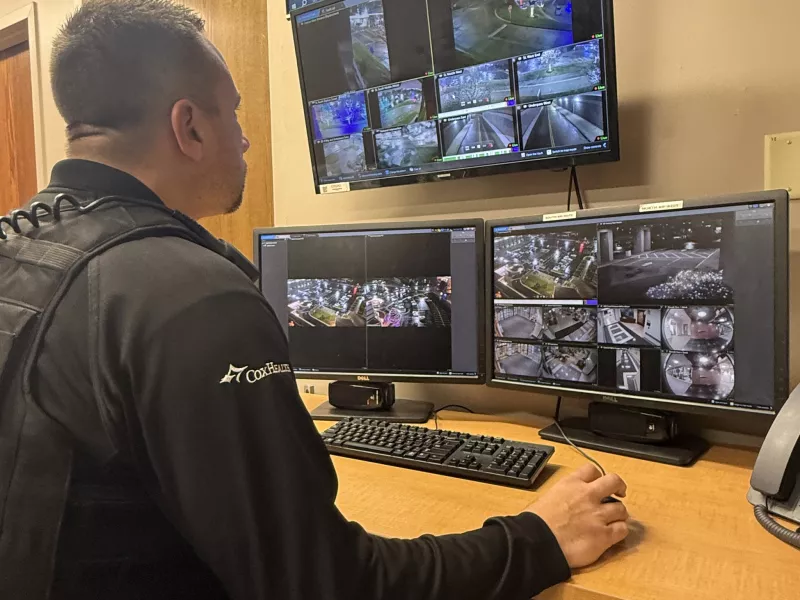 Security officer in SOC looking at displays