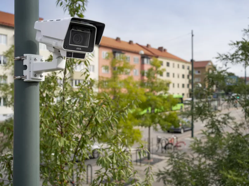Box camera mounted on pole with blurred background