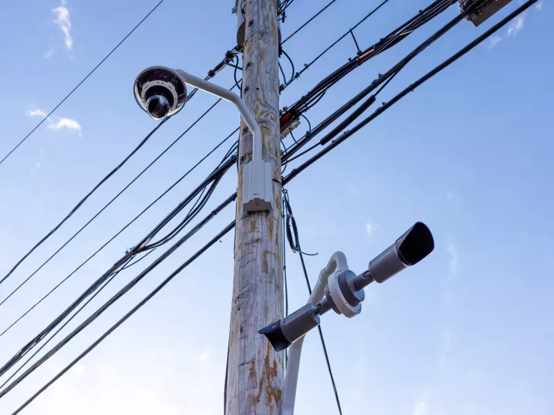 A PTZ and bullet camera mounted on telephone pole on university campus