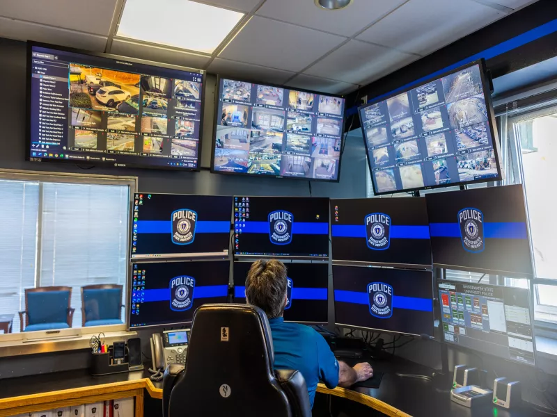 Police dispatch center showing streaming video footage from cameras