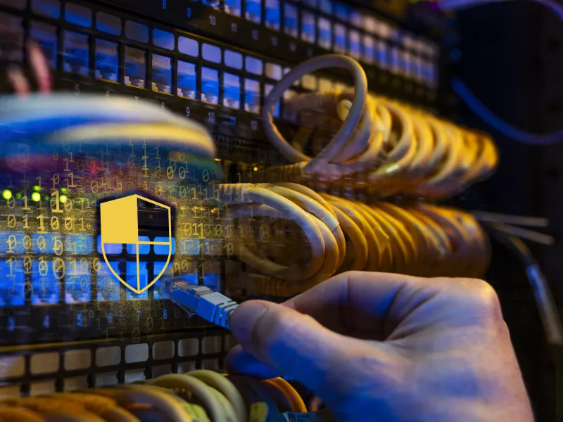 Cybersecurity image with lots of cables and a hand 