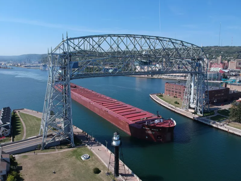 Duluth aerial lift bridge raised to allow ship to pass underneath