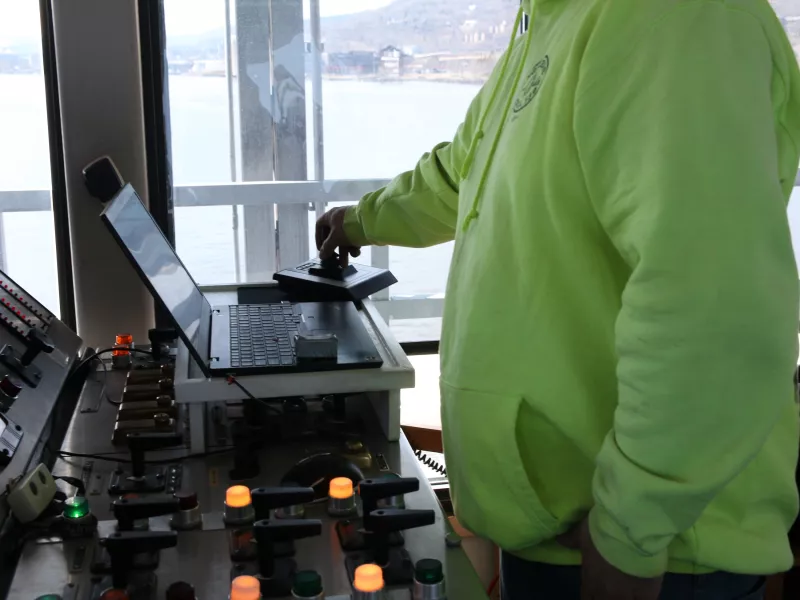 Pilot operating joystick to raise or lower aerial bridge