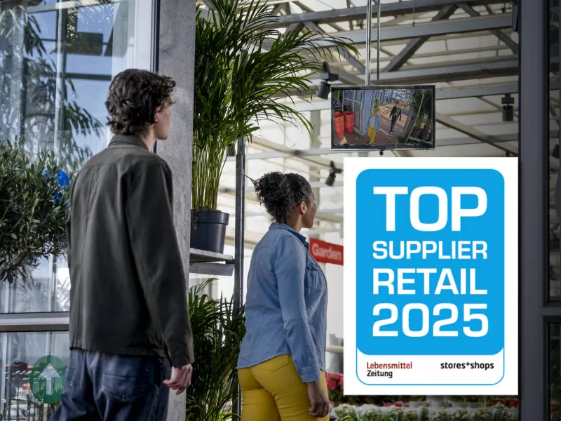 People entering a super market with an award logo