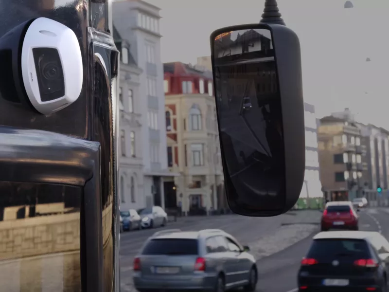 AXIS P3925-LRE Network Camera placed on the side of a bus driving in Malmö City. 